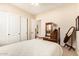 Cozy bedroom with neutral carpet, twin bed and vintage dark wood furniture at 2457 E Melrose St, Mesa, AZ 85213