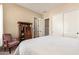 Comfortable bedroom with white bed linens, vintage furniture, and lots of natural light at 2457 E Melrose St, Mesa, AZ 85213