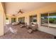 A covered patio featuring ceiling fans, tiled floors, and outdoor seating at 2457 E Melrose St, Mesa, AZ 85213