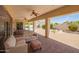 Covered patio overlooking the swimming pool and green backyard at 2457 E Melrose St, Mesa, AZ 85213