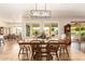 Dining room with a stylish light fixture and windows that provide natural light and backyard views at 2457 E Melrose St, Mesa, AZ 85213