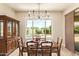 Warm dining room offers a picturesque view of the backyard pool through the bright windows at 2457 E Melrose St, Mesa, AZ 85213