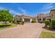 Stunning one-story home featuring a tile roof, lush landscaping, and paved driveway at 2457 E Melrose St, Mesa, AZ 85213