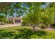 Charming home with a tile roof, mature landscaping, and an attached two-car garage at 2457 E Melrose St, Mesa, AZ 85213