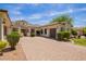 Spacious one-story home with a tiled roof, lush landscaping and an extended paver driveway at 2457 E Melrose St, Mesa, AZ 85213