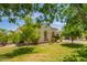 Well-maintained front yard with lush greenery, mature trees and decorative bushes at 2457 E Melrose St, Mesa, AZ 85213
