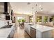 Bright open kitchen with a big island, stainless steel appliances, and seamless transitions to dining areas at 2457 E Melrose St, Mesa, AZ 85213