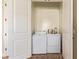 Enclosed laundry room with white washer and dryer and tiled floor at 2457 E Melrose St, Mesa, AZ 85213