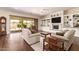 Bright living room featuring a fireplace, custom built-ins, and access to the outdoor living space at 2457 E Melrose St, Mesa, AZ 85213
