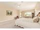 Large main bedroom with seating area, slider to patio, and picture window bringing in natural light at 2457 E Melrose St, Mesa, AZ 85213