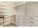 Spacious walk-in closet features custom shelving, drawers, and ample storage space, perfect for organizing your wardrobe at 2457 E Melrose St, Mesa, AZ 85213