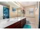 Bright bathroom features double sinks, a large mirror, and neutral tile flooring at 25806 W Hilton Ave, Buckeye, AZ 85326