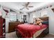 Bedroom decorated with sports-themed decorations and a dark wooden bed frame and furnishings at 25806 W Hilton Ave, Buckeye, AZ 85326