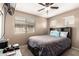 Comfortable bedroom featuring a ceiling fan, TV, and natural light from a bright window at 25806 W Hilton Ave, Buckeye, AZ 85326