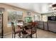 Bright breakfast nook with a round table, seating for four, and views of the swimming pool at 25806 W Hilton Ave, Buckeye, AZ 85326