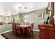 Cozy dining room with a wooden table and chairs set on patterned rug at 25806 W Hilton Ave, Buckeye, AZ 85326