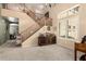 Open foyer with staircase, carpeted floors and clerestory windows for natural light at 25806 W Hilton Ave, Buckeye, AZ 85326