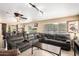 Spacious living room with a large sectional sofa, tile flooring, and views to the backyard at 25806 W Hilton Ave, Buckeye, AZ 85326