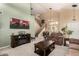 Inviting living room with plush seating, a fireplace, and an open staircase at 25806 W Hilton Ave, Buckeye, AZ 85326