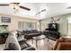 Comfortable living room featuring a sectional sofa, tile flooring, and a ceiling fan at 25806 W Hilton Ave, Buckeye, AZ 85326