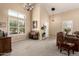 Bright living room with high ceilings, carpeted floors, and ample natural light at 25806 W Hilton Ave, Buckeye, AZ 85326
