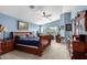 Large main bedroom with blue painted walls and a ceiling fan and vaulted ceiling at 25806 W Hilton Ave, Buckeye, AZ 85326