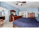 Main bedroom with neutral carpet, blue walls and wooden furniture sets at 25806 W Hilton Ave, Buckeye, AZ 85326