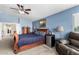 Spacious main bedroom with wooden furniture and comfortable sitting area with blue walls at 25806 W Hilton Ave, Buckeye, AZ 85326