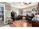 Home office with hardwood floors, ceiling fan, and multiple desks for a productive workspace at 25806 W Hilton Ave, Buckeye, AZ 85326