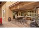 Charming patio area with tile flooring, outdoor seating, and a built-in grill at 25806 W Hilton Ave, Buckeye, AZ 85326