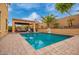 Inviting backyard pool area with a covered patio, mature palm trees, and ample seating at 25806 W Hilton Ave, Buckeye, AZ 85326