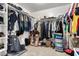 Walk-in closet with clothes racks and multiple storage units and carpet floors at 25806 W Hilton Ave, Buckeye, AZ 85326