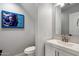 Stylish powder room featuring modern fixtures, a square sink, and unique artwork at 2604 N 27Th St # 4, Phoenix, AZ 85008
