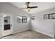 Cozy bedroom with multiple windows, a ceiling fan, and a glass door to outside at 2604 N 27Th St # 4, Phoenix, AZ 85008