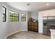 Bright kitchen area with white cabinets, stainless steel appliances, and views from black-framed windows with light wood flooring at 2604 N 27Th St # 4, Phoenix, AZ 85008
