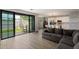 Open living area transitions from indoor to outdoor spaces with sliding glass doors and modern furnishings adjacent to a kitchen at 2604 N 27Th St # 4, Phoenix, AZ 85008