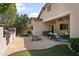 Spacious backyard with a covered patio, outdoor kitchen, manicured lawn, and privacy fence at 2736 E Sourwood Dr, Gilbert, AZ 85298
