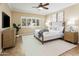 Serene bedroom with light walls, a ceiling fan, window shutters, and tile flooring at 2736 E Sourwood Dr, Gilbert, AZ 85298