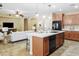 Well-designed kitchen island, black appliances, modern fixtures, and an open layout to the living area at 2736 E Sourwood Dr, Gilbert, AZ 85298