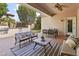 Inviting covered patio with comfortable seating, outdoor kitchen, ceiling fan and well-maintained landscaping at 2736 E Sourwood Dr, Gilbert, AZ 85298