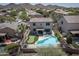 Aerial view showcases a backyard with a pool, putting green, and patio for ultimate outdoor living at 29110 N 24Th Ln, Phoenix, AZ 85085