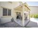 Charming covered patio with a dining set, stylish pavers, and backyard access is perfect for outdoor entertaining at 29110 N 24Th Ln, Phoenix, AZ 85085