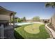 Beautiful backyard with pool, putting green, rock detail, and covered patio at 29110 N 24Th Ln, Phoenix, AZ 85085