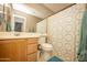 Well-lit bathroom features a large mirror, floral shower curtain, and a wood vanity at 29110 N 24Th Ln, Phoenix, AZ 85085