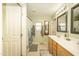 Well-lit bathroom with double sinks, modern fixtures, and a decorative shower curtain at 29110 N 24Th Ln, Phoenix, AZ 85085
