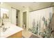Bright bathroom featuring dual sinks, framed mirrors and cactus themed shower curtain at 29110 N 24Th Ln, Phoenix, AZ 85085