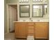Bright bathroom with a double sink vanity, stylish mirrors, and tile flooring offers a clean design at 29110 N 24Th Ln, Phoenix, AZ 85085