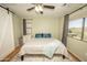 Light-filled bedroom with views, a ceiling fan, and a comfortable bed creates a peaceful retreat at 29110 N 24Th Ln, Phoenix, AZ 85085