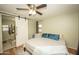 Bedroom featuring a ceiling fan, hardwood floors, and an ensuite bathroom at 29110 N 24Th Ln, Phoenix, AZ 85085