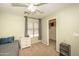 Cozy bedroom with carpet, a ceiling fan, and a closet provides a comfortable and functional living space at 29110 N 24Th Ln, Phoenix, AZ 85085